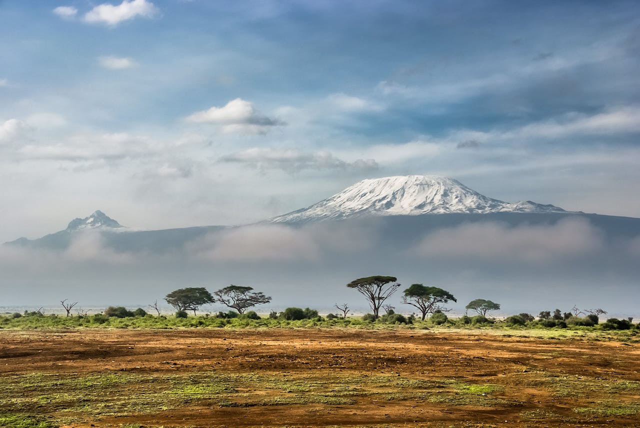 Breathtaking view of snow-capped Mount Kilimanjaro with surrounding African savannah.